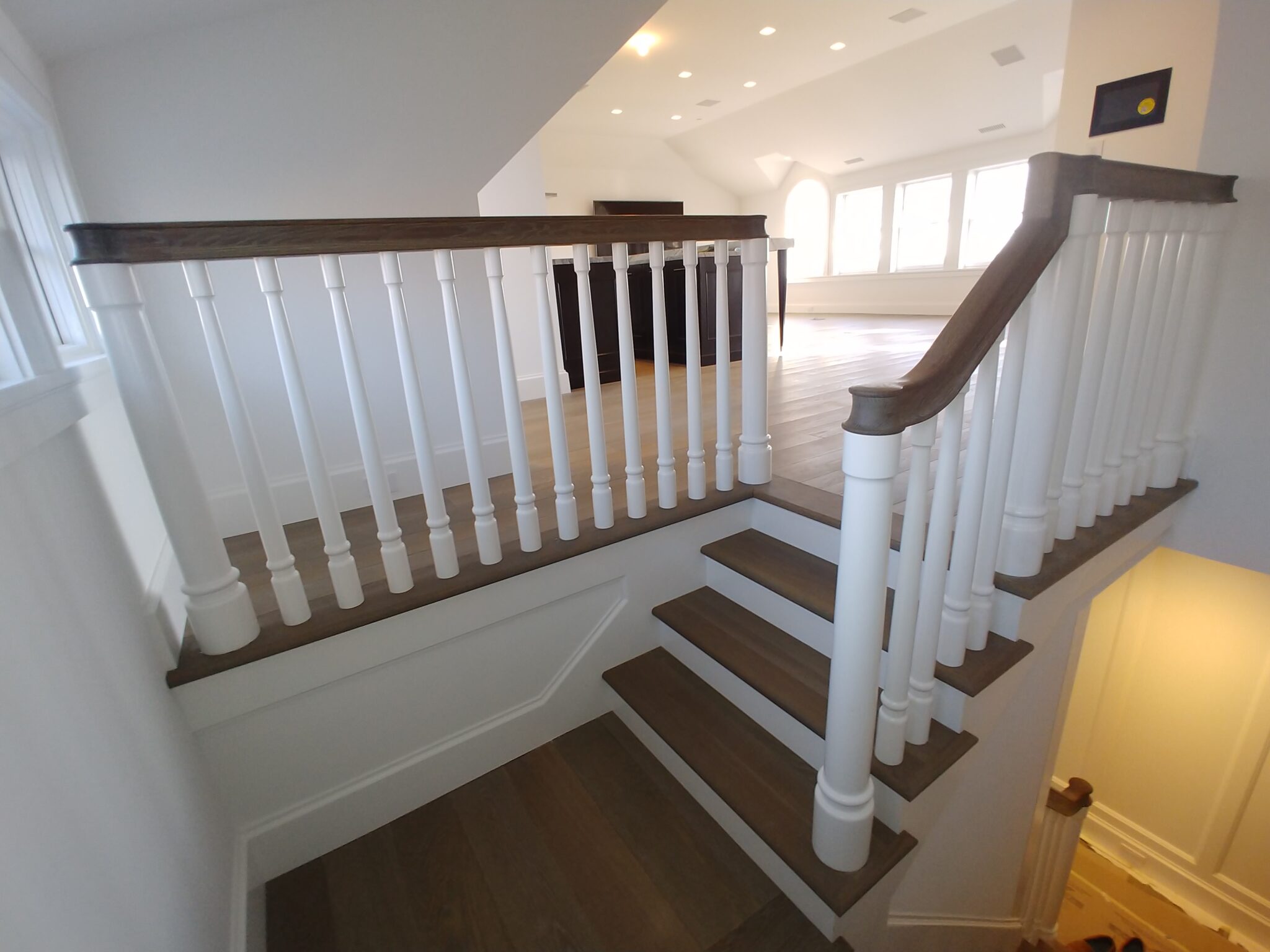 The new hardwood flooring with foyer stairs