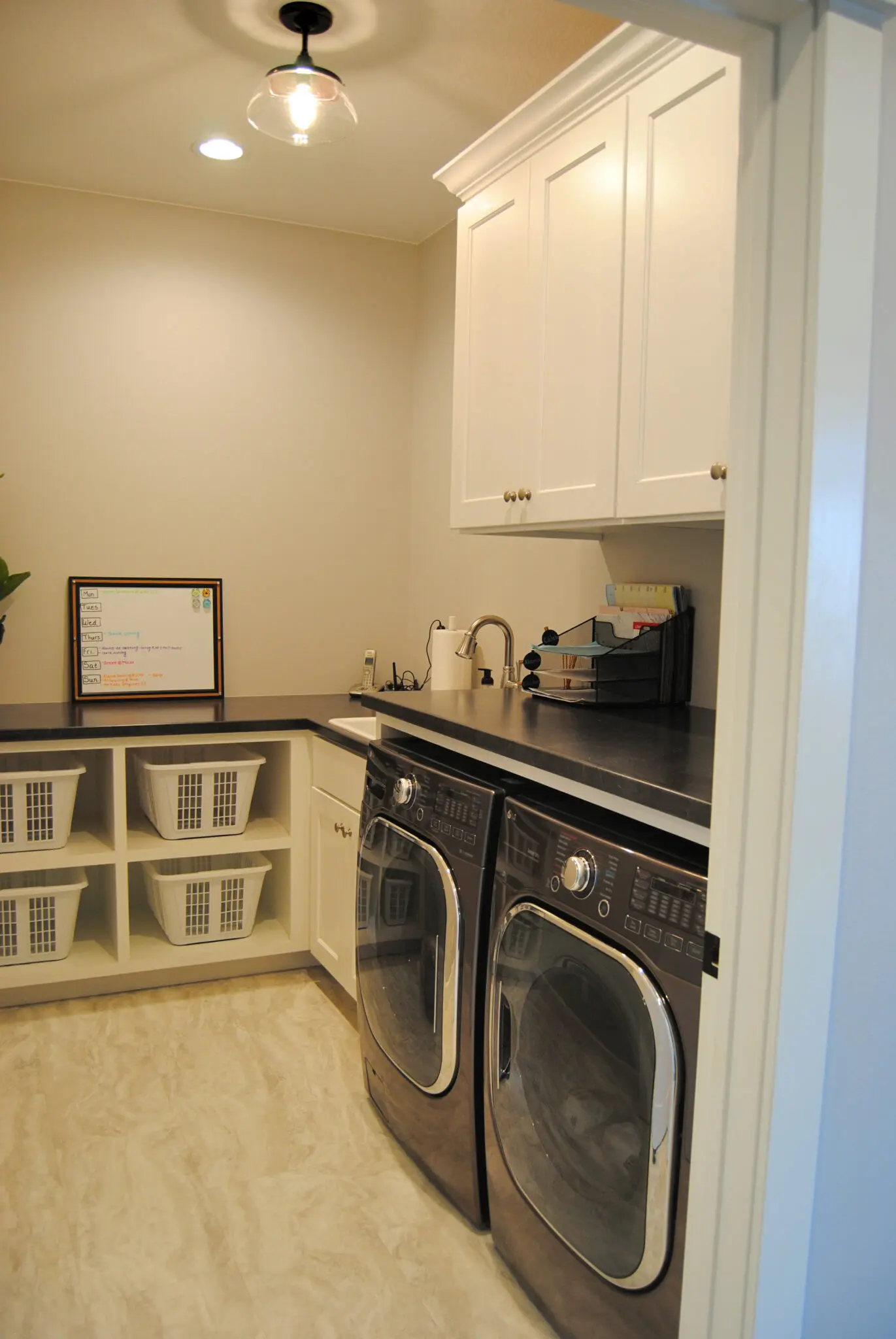 Utility room with washer, laundry vanities and closet space