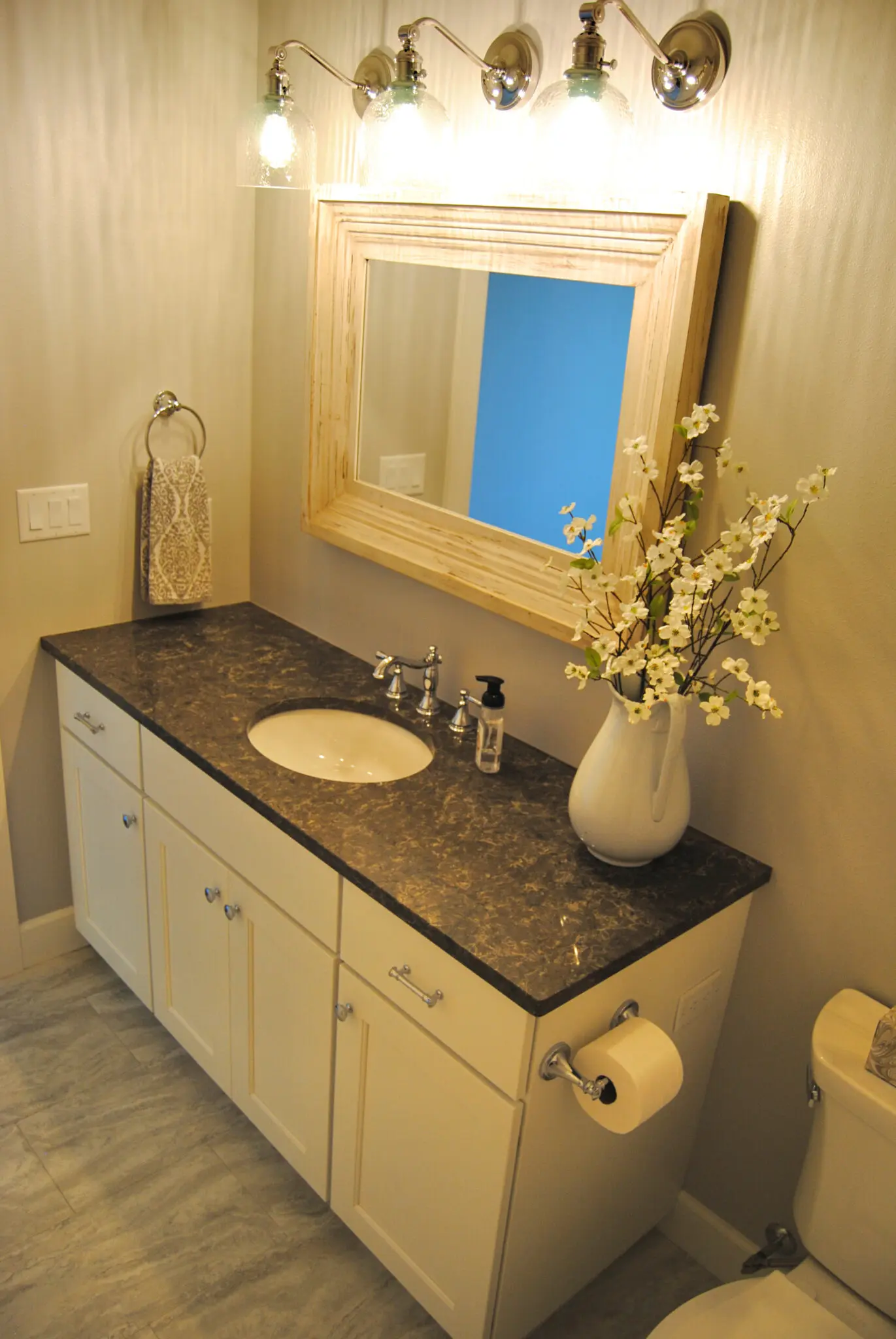 Modern bathroom renovation with framed mirror and cabinets