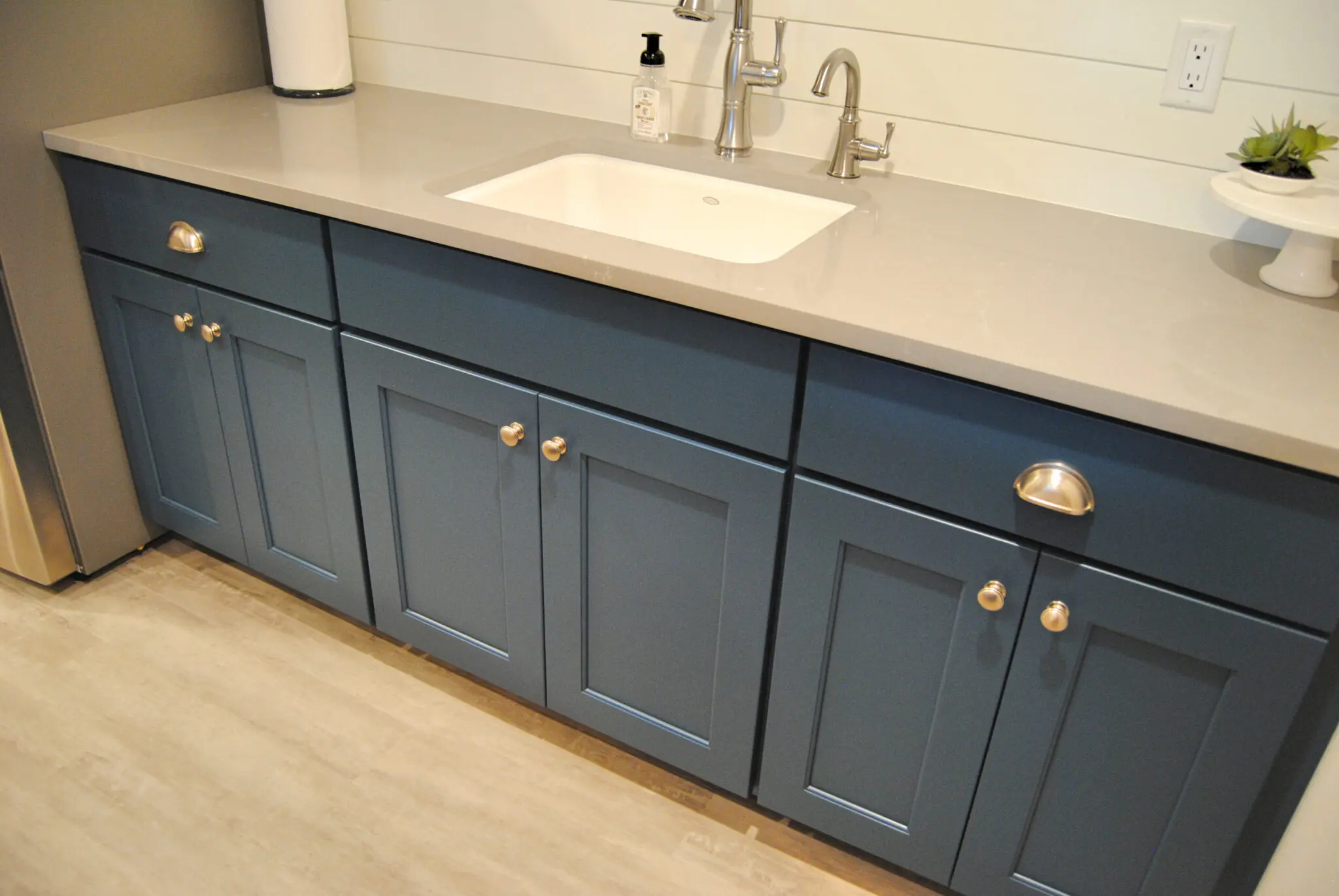 The house sink unit with gray bathroom wall cabinet