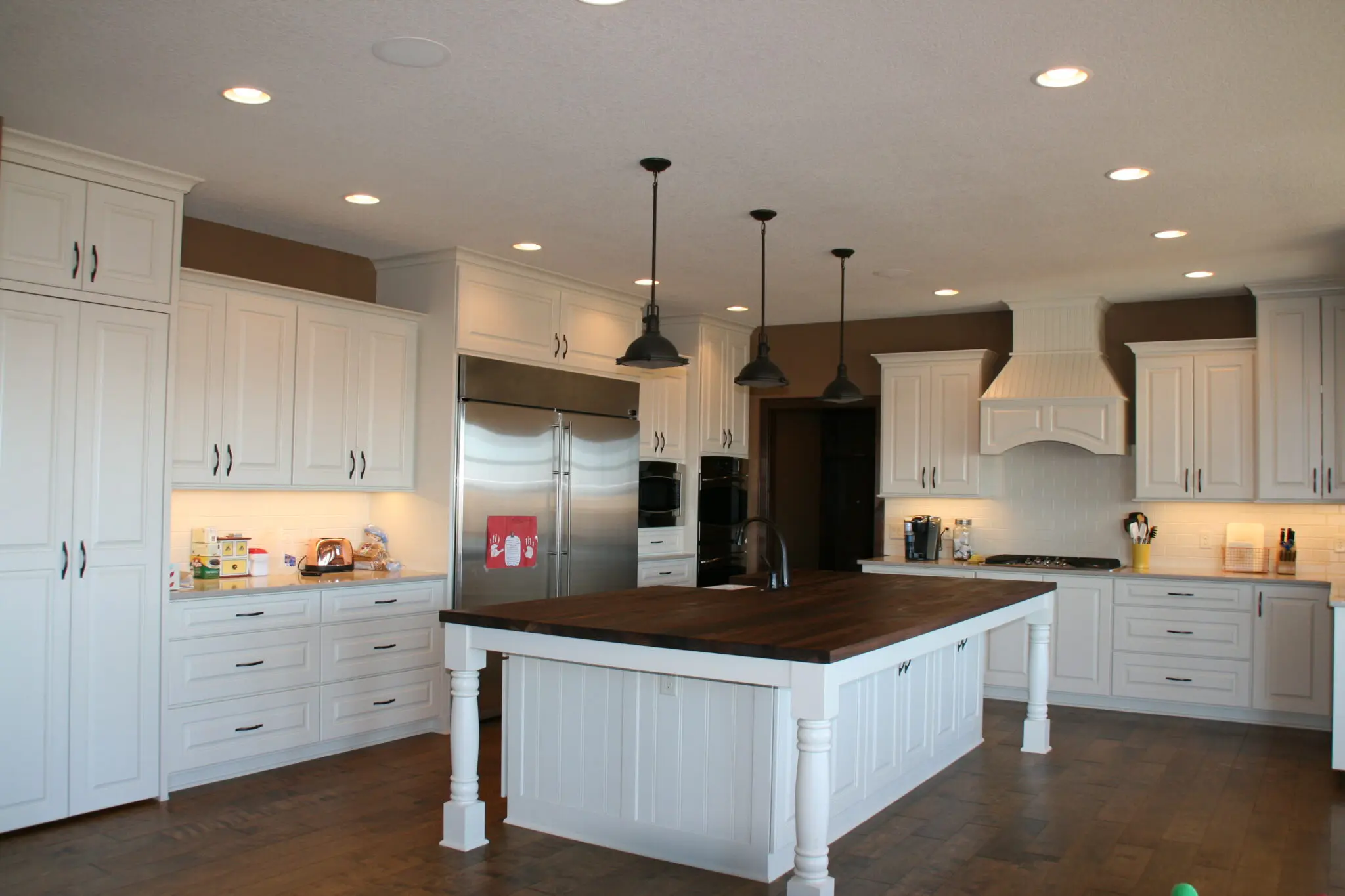 Open kitchen plan with custom white cabinets